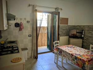 a kitchen with a table and a kitchen with a stove at Casa del Coro in Perugia