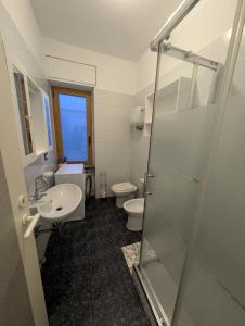 a bathroom with a shower and a sink and a toilet at Casa del Coro in Perugia