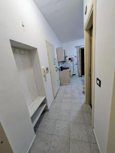 a hallway in a kitchen with white walls at Casa del Coro in Perugia