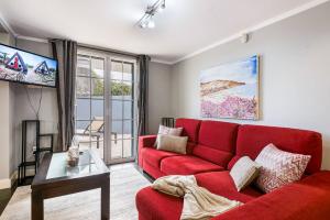 a living room with a red couch and a tv at Villa Santana by GALMI in Santana