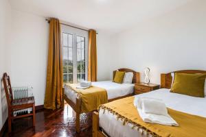 a bedroom with two beds and a window at Villa Santana by GALMI in Santana