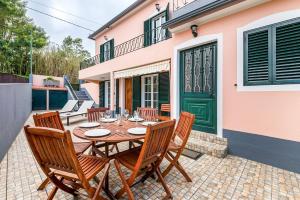 a wooden table and chairs on a patio at Villa Santana by GALMI in Santana