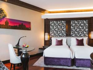 a hotel room with two beds and a table at Sofitel Mumbai BKC in Mumbai +226 photos