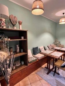 a room with a couch and a table at Hôtel Le Square in Capvern