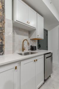 a kitchen with white cabinets and a sink at Park Hotel Studio Suite 403 in Chattanooga