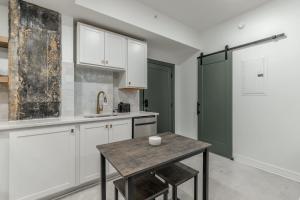 a kitchen with white cabinets and a wooden table at Park Hotel Studio Suite 403 in Chattanooga