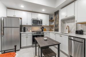 a kitchen with white cabinets and a table in it at Park Hotel Studio Suite 403 in Chattanooga