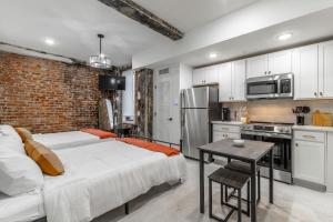 a kitchen with two beds and a brick wall at Park Hotel Studio Suite 403 in Chattanooga +12 photos
