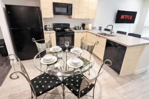 a kitchen with a glass table and chairs in it at The Luxe Black Haven (340) in Des Moines +30 photos