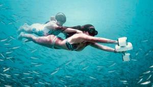 a man and woman swimming in the water with a skateboard at Mountain Chalet with Awesome Sea View in Loma Partida +88 photos