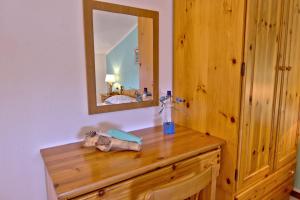 a bathroom with a wooden dresser with a mirror at Casa Gabriella in Fetovaia +88 photos