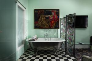a bathroom with a tub and a painting on the wall at 24 Royal Terrace in Edinburgh +117 photos