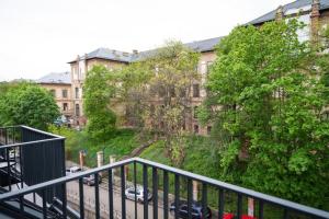 a balcony of a building with cars parked on the street at Ophir Apartment Ultracentral,the greenest and brightest central area,3 parking space in the large yard in Cluj-Napoca +27 photos