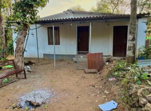 a small house with a fence in front of it at Sree vinayaka homestay in Vagamon +3 photos