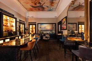 a bar with tables and chairs in a room with a ceiling at 24 Royal Terrace in Edinburgh