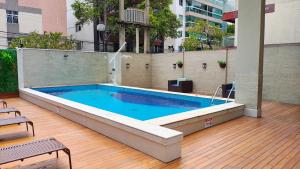 a large swimming pool on a deck next to a building at Alameda Vitória Hotel in Vitória