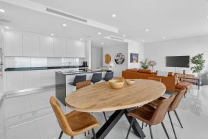 a kitchen and living room with a wooden table and chairs at Penthouse by the Marina in Lagos