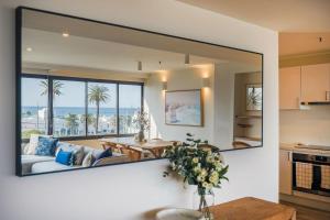 a large mirror in a room with a living room at Luxury Beach View Escape in Melbourne