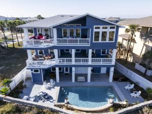 an aerial view of a blue house with a swimming pool at Horizon House Stay. Relax. Repeat. in Port Aransas