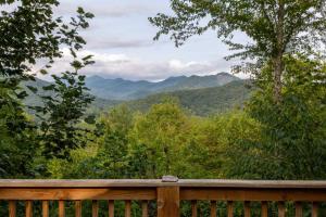 a wooden deck with a view of mountains at Summerset Ridge in Cullowhee