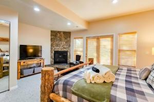 a living room with a bed and a tv at Rustic Ridge MH304 Near Powder Mtn Hot Tub in Eden
