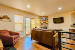 a living room with a couch and a tv at Rustic Ridge MH304 Near Powder Mtn Hot Tub in Eden