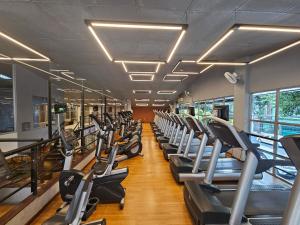 a gym with a row of treadmills at Alameda Vitória Hotel in Vitória