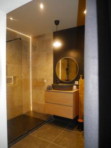 a bathroom with a sink and a mirror at Le Petit Provençal in Sénas +37 photos