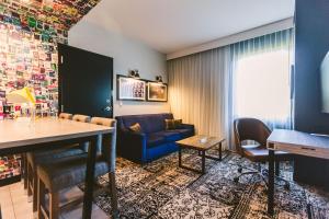 a living room with a blue couch and a table at Hotel Rock Lititz in Lititz