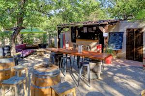 a table and chairs and a table and some barrels at Camping Verdon familial 3 étoiles - 20 min du lac de Sainte Croix in Esparron-de-Verdon