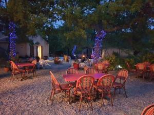 a group of tables and chairs with christmas lights at Camping Verdon familial 3 étoiles - 20 min du lac de Sainte Croix in Esparron-de-Verdon