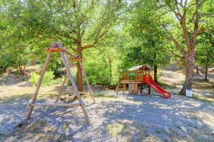 a playground with a slide and a swing set at Camping Verdon familial 3 étoiles - 20 min du lac de Sainte Croix in Esparron-de-Verdon