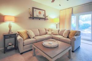 a living room with a couch and a coffee table at Harbour Town Haven in Hilton Head Island