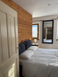 a bedroom with a white bed and a mirror at Mezzodì Locazione Turistica in Colcerver +2 photos