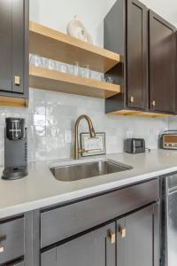 a kitchen with a sink and wooden cabinets at Park Hotel 2BR Suite 406 in Chattanooga