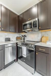 a kitchen with stainless steel appliances and a microwave at Park Hotel 2BR Suite 406 in Chattanooga
