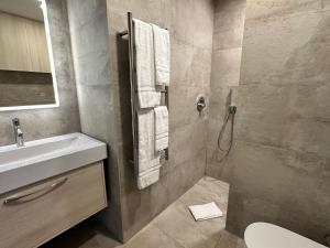 a bathroom with a sink and a shower with towels at Casa Luca in Carvoeiro +21 photos