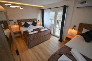 a hotel room with two beds and a balcony at Five stars in Dubrava +35 photos