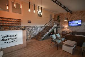 a living room with a couch and a staircase at Five stars in Dubrava