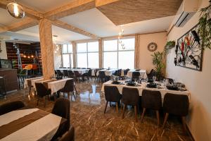 a restaurant with tables and chairs in a room at Five stars in Dubrava