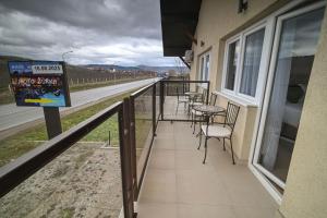 a balcony with tables and chairs on the side of a building at Five stars in Dubrava