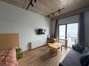 a living room with a couch and a table at Art house in Kʼumlistsʼikhe