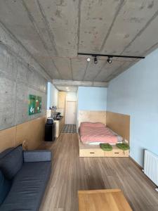 a bedroom with a bed and a couch in a room at Art house in Kʼumlistsʼikhe