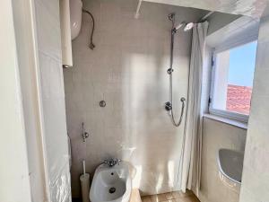 a bathroom with a shower with a toilet and a sink at La Torre in San Vincenzo +16 photos