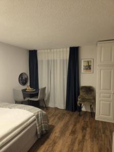 a bedroom with a bed and a table and a chair at Apartment 401 in Bergün +23 photos
