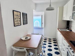 a small kitchen with a wooden table and a sink at La Torre in San Vincenzo
