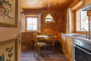 a kitchen with a table and a dining room at Bauernhof im Wiesengrund in Maria Luggau