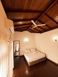 a bedroom with a bed and a ceiling fan at Peaceful Paradise Villa in Kandy +39 photos