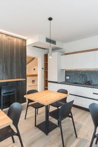 a dining room with a table and chairs in a kitchen at Relais del Borgo in Lentiai +18 photos