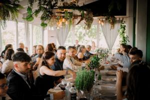 a group of people sitting at tables at a dinner party at Corte Tommasi Residence in Orentano +87 photos
